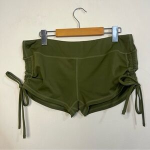 Green Athletic Shorts with Adjustable Side Ties and Curved Hem